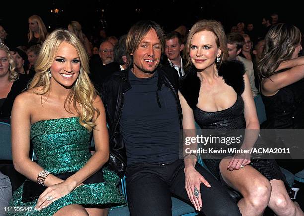 Singer Carrie Underwood, musician Keith Urban and actress Nicole Kidman pose in the audience at the 46th Annual Academy Of Country Music Awards held...