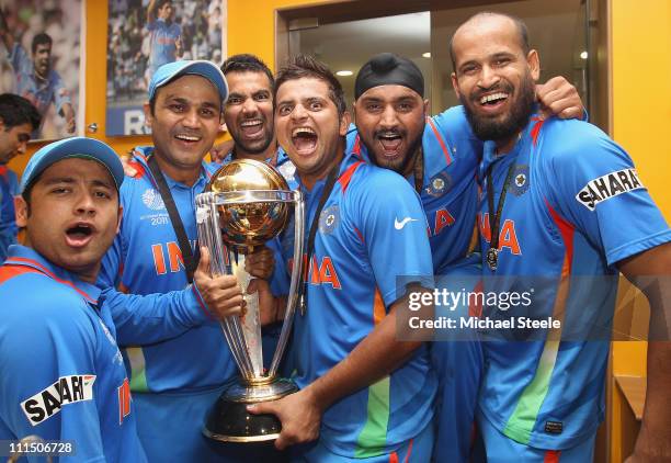 Piyush Chawla ,Virender Sehwag ,Zaheer Khan ,Suresh Raina ,Harbhajan Singh and Yusuf Pathan pose with the world cup trophy in the players dressing...