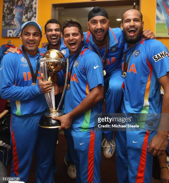 Virender Sehwag ,Zaheer Khan ,Suresh Raina ,Harbhajan Singh and Yusuf Pathan pose with the world cup trophy in the players dressing room after their...