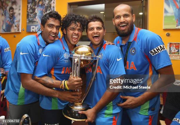 Ravichandran Ashwin ,Shanthakumaran Sreesanth ,Suresh Raina and Yusuf Pathan pose with the world cup trophy in the players dressing room after their...