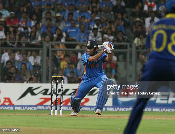 Skipper M.S. Dhoni strikes during the World Cup final match between India and Sri Lanka at Wankhade Stadium in Mumbai on Saturday, April 02, 2011.