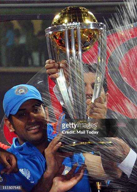 Indian Cricket Team Mahendra Singh Dhoni poses with the trophy after victory in the Cricket World Cup 2011 final over Sri Lanka at The Wankhede...