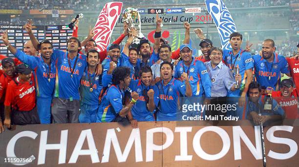 Indian cricketers pose with the trophy after victory in the Cricket World Cup 2011 final over Sri Lanka at The Wankhede Stadium in Mumbai on April 2,...