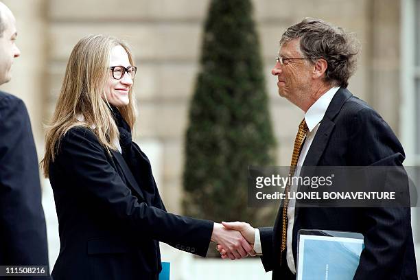 Microsoft founder and philanthropist Bill Gates shakes hands with Consuelo Remmert, half sister of Carla Bruni-Sarkozy as he leaves the Elysee...
