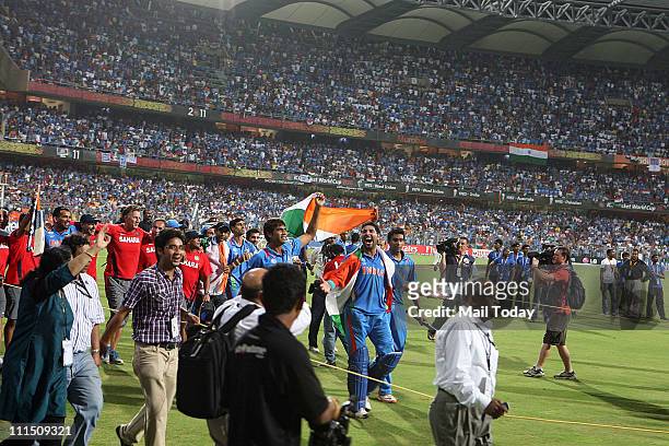 Indian Player Yuvraj Singh celebrates with team members after winning the ICC Cricket World Cup 2011 Final match at The Wankhede Stadium in Mumbai on...