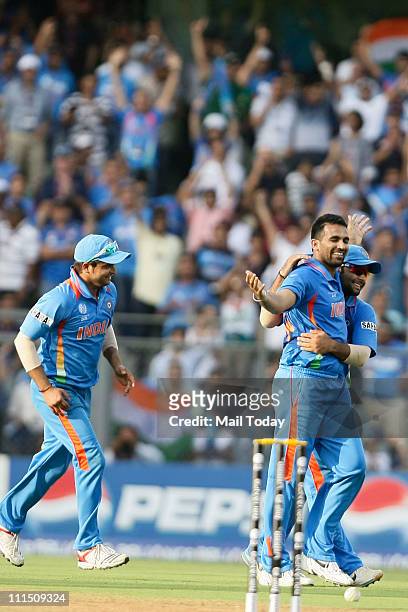Indian team celebrate the wicket of a Sri Lankan player during the ICC Cricket World Cup 2011 Final match at The Wankhede Stadium in Mumbai on April...