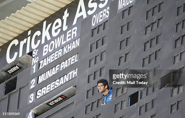 Man watching the match near the score board during the ICC Cricket World Cup 2011 Final match at The Wankhede Stadium in Mumbai on April 2, 2011....