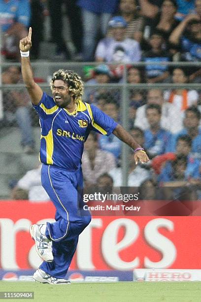Sri Lankan bowler Lasith Malinga reacts after taking the wicket of Sachin Tendulkar during the ICC Cricket World Cup 2011 Final match at The Wankhede...