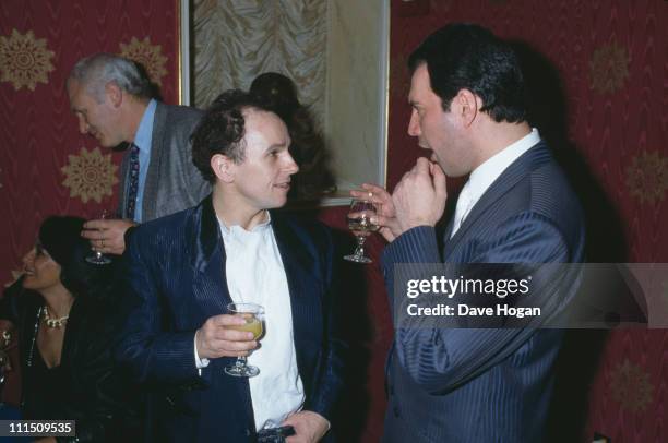 Singer Freddie Mercury of Queen talks to dancer Wayne Sleep at a party for the new cast of the musical '42nd Street' in London, 7th April 1987.