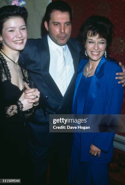 Singer Freddie Mercury of Queen with actresses Catherine Zeta Jones and Jill Gascoine at a party for the new cast of the musical '42nd Street' in...