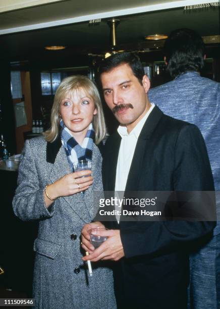 Singer Freddie Mercury of Queen attends Fashion Aid at the Royal Albert Hall in London, with his friend Mary Austin, 5th November 1985.