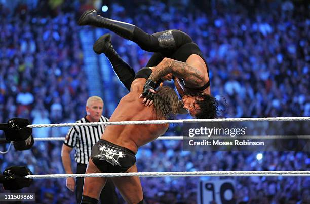 Triple H and Undertaker battle during their WWE No Holds Barred Match at 'WrestleMania 27' at the Georgia World Congress Center on April 3, 2011 in...