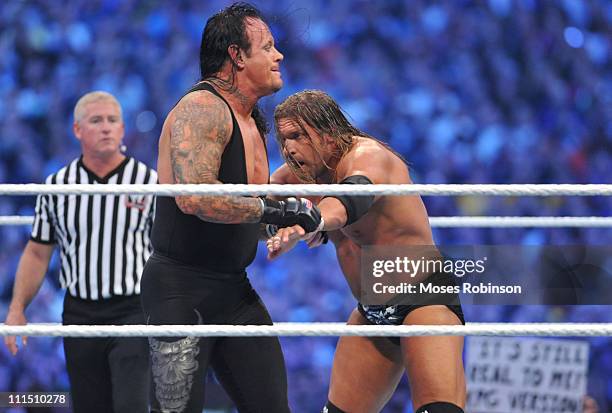 Triple H and The Undertaker Randy Orton and Triple H battle during their WWE match at 'WrestleMania 27' at the Georgia World Congress Center on April...