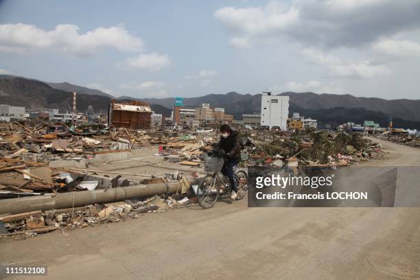 Person rides a bike amid debris April 3, 2011 in Ohfunato, Japan. The 9.0 magnitude strong earthquake struck offshore on March 11 at 2:46pm local...