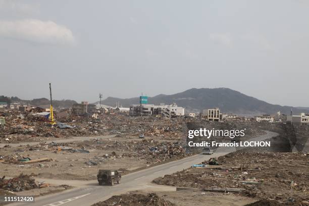 Vehicles drive down a street April 2, 2011in Rikusen Takata City, Japan. The 9.0 magnitude strong earthquake struck offshore on March 11 at 2:46pm...