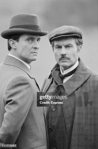 English actors Jeremy Brett and David Burke star in the television series 'The Adventures of Sherlock Holmes', UK, 7th March 1984.