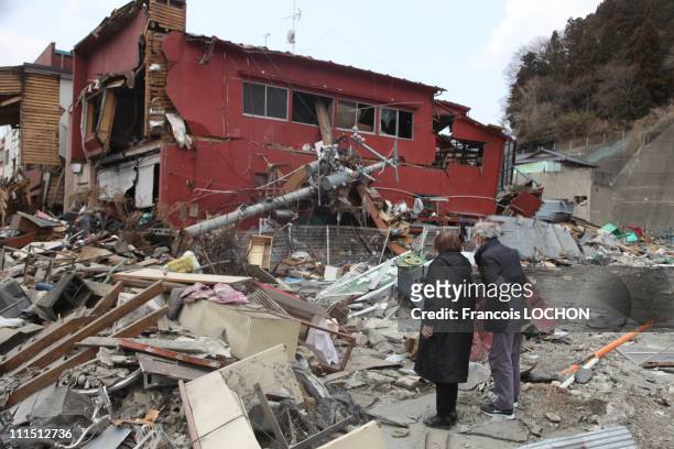 Couple stands in front of their destroyed house April 2, 2011 in Kamaishi, Japan. The 9.0 magnitude strong earthquake struck offshore on March 11 at...