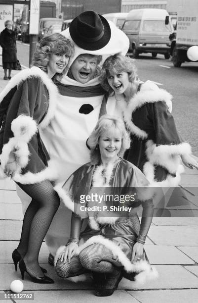 British comedian Benny Hill poses in a Christmas costume, 16th December 1983.