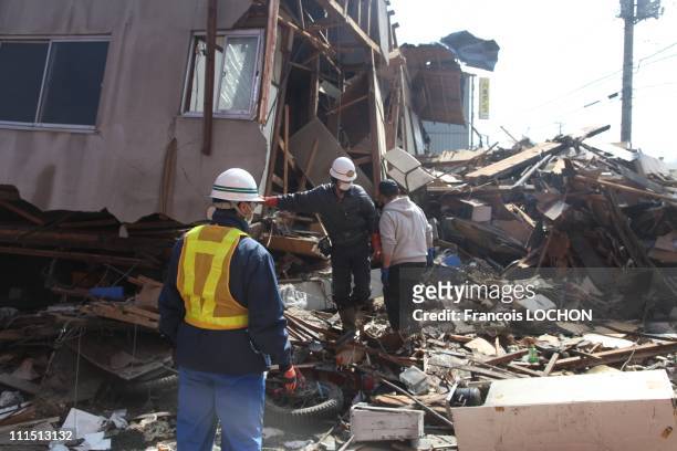Men stand among debris April 3, 2011 in Myako City, Japan. The 9.0 magnitude strong earthquake struck offshore on March 11 at 2:46pm local time,...