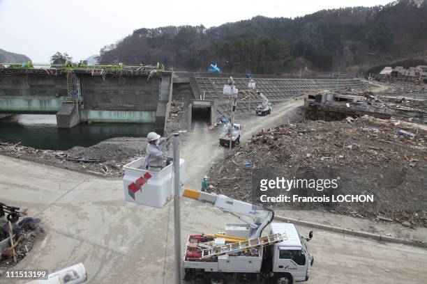 Technicians begin to fix the electricity lines April 3, 2011 in the village of Touni, Japan. The 9.0 magnitude strong earthquake struck offshore on...