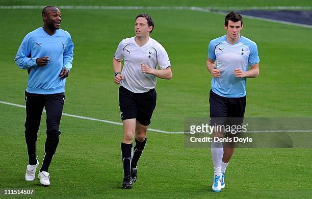Gareth Bale and William Gallas of Tottenham Hotspur warm up with a memeber of the coaching staff during a training session a day before the UEFA...