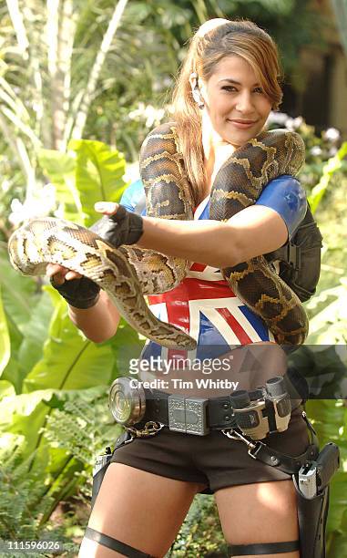 The new face of Lara Croft, Karima Adebibe with the help of her Burmese Python at a photocall for the new Tomb Raider "Legend" game