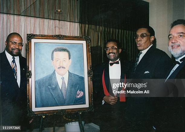 Attorney Johnnie Cochran is honored by the Brotherhood Crusade at their annual banquet. Flanking a portrait of Cochran is Mohammad Mubarak , Johnnie...