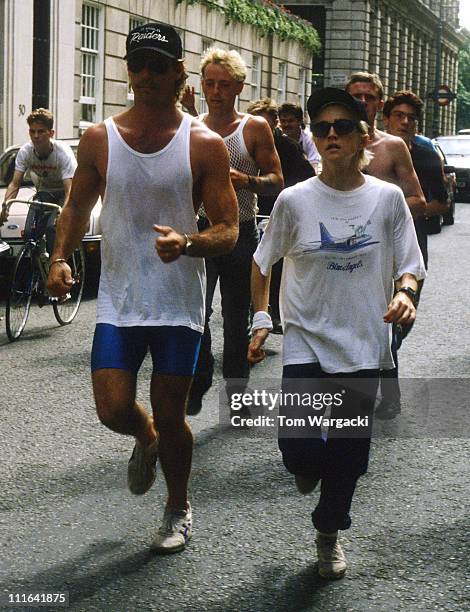 Madonna at The Mayfair Hotel jogging with personal trainer and bodyguards