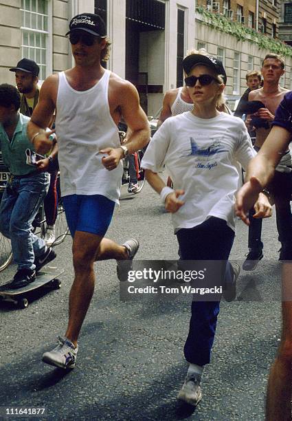 Madonna at The Mayfair Hotel jogging with personal trainer and bodyguards