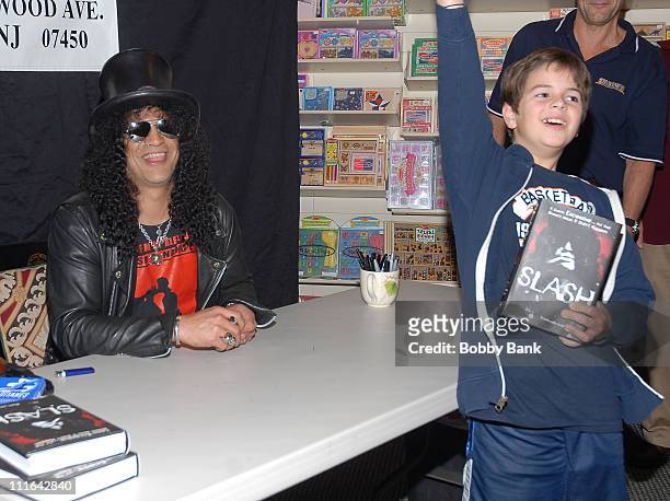Slash and young fan at the "Slash" book signing at Bookends Bookstore on November 1, 2007 in Ridgewood, New Jersey.