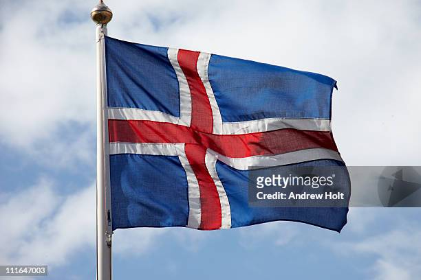 icelandic flag of iceland against sky - icelandic flag stock pictures, royalty-free photos & images