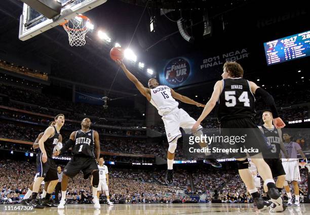 Kemba Walker of the Connecticut Huskies goes to the basket against Matt Howard and Shelvin Mack of the Butler Bulldogs during the National...