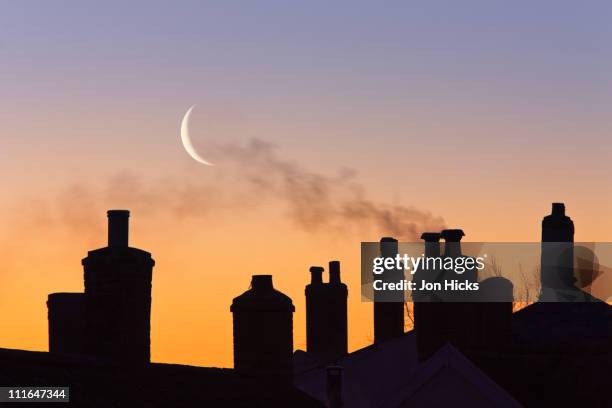 crescent moon and chimney stacks. - chimney roof stock pictures, royalty-free photos & images