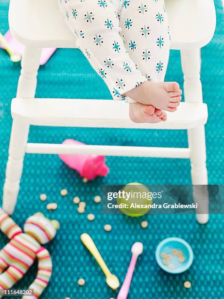 baby in high chair - baby eating toy stock pictures, royalty-free photos & images