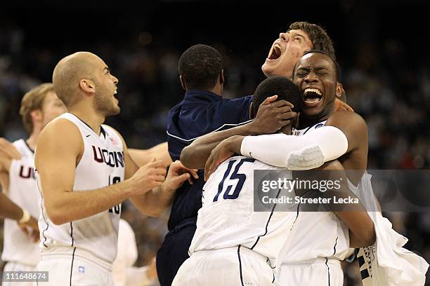 Kemba Walker, Donnell Beverly and Tyler Olander of the Connecticut Huskies react after defeating the Butler Bulldogs to win the National Championship...