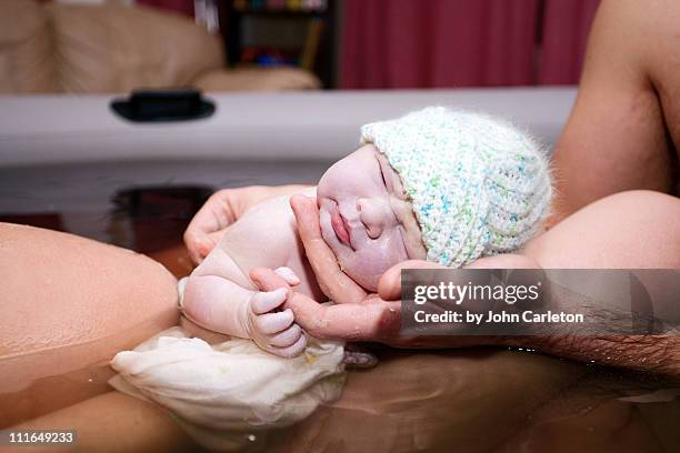 brand new baby born via natural home water birth - home birth stock-fotos und bilder