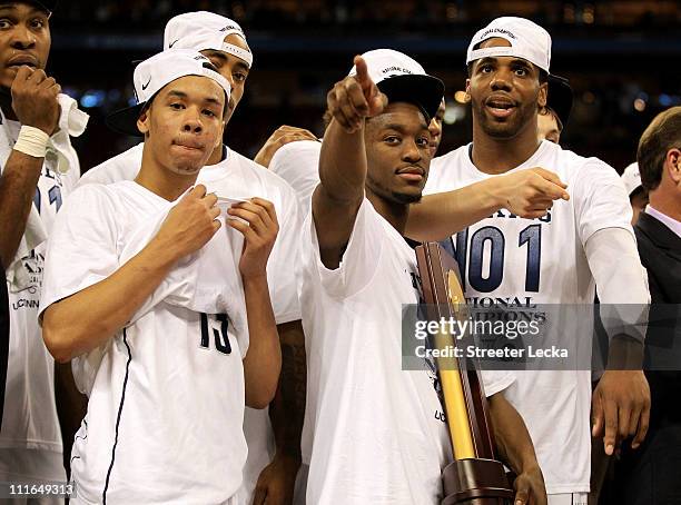 Kemba Walker, Shabazz Napier and Alex Oriakhi of the Connecticut Huskies celebrate with the trophy after defeating the Butler Bulldogs to win the...