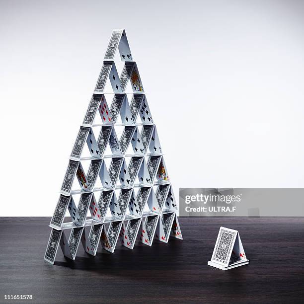 big card tower and small card tower - card house stock pictures, royalty-free photos & images