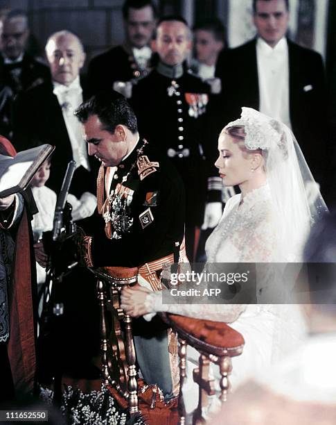 Photo taken on April 19, 1956 shows US actress Grace Kelly and Prince Rainier of Monaco during their wedding ceremony in Monaco. AFP PHOTO