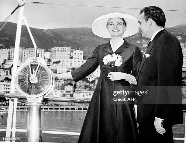 Prince Rainier III of Monaco and his fiancee US actress Grace Kelly are all smile aboard the princely yacht "Deo Juvante II" on April 12, 1956 in...