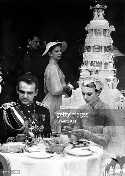 Prince Rainier III of Monaco and US actress and Princess of Monaco Grace Kelly are seen during their wedding lunch in Monaco on April 19, 1956.