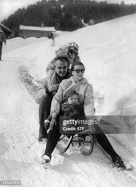 Prince Rainier and Princess Grace of Monaco and children Caroline and Albert slide down a road in Switzerland during winter vacations, 26 February...