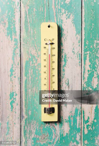 thermometer on a weathered wooden wall - termometer bildbanksfoton och bilder