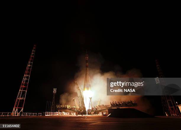 In this handout image provided by NASA, the Soyuz TMA-21 launches from the Baikonur Cosmodrome on April 5, 2011 in Baikonur, Kazakhstan. The...