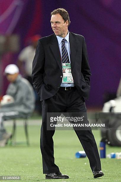 Australia's coach Holger Osieck smiles after his team scored another goal against Uzbekistan during their 2011 Asian Cup semi-final football match in...