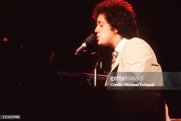 Billy Joel performs on stage, USA, 1977.