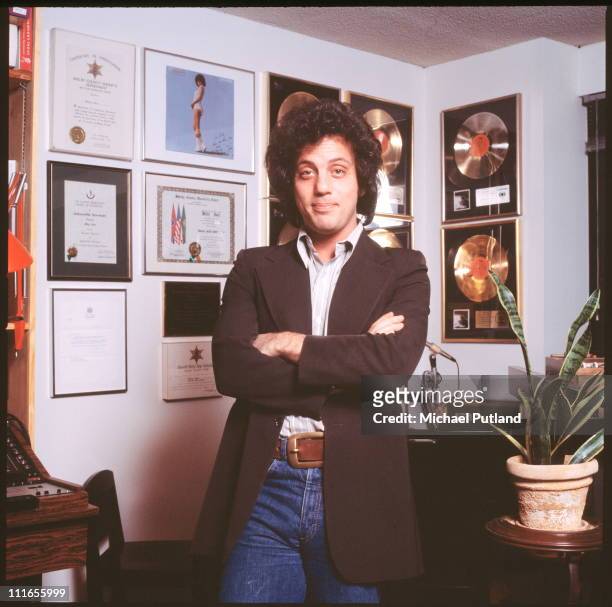 Billy Joel, portrait, at home in front of gold discs, New York, 25th January 1978.