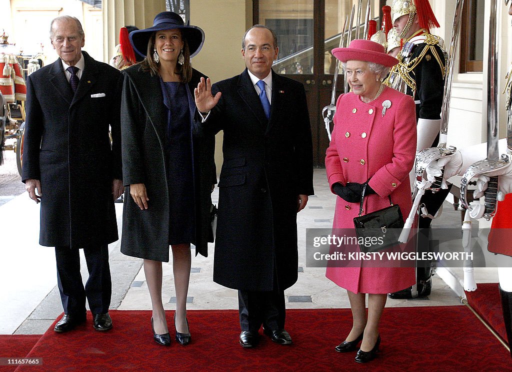 Britain's Queen Elizabeth II (R) stands