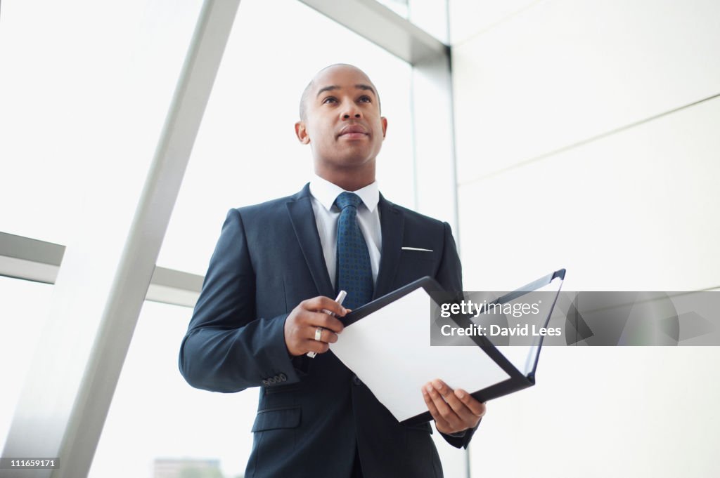 Businessman holding paperwork