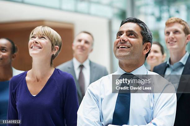 group of businesspeople looking up - group of people looking up stock pictures, royalty-free photos & images